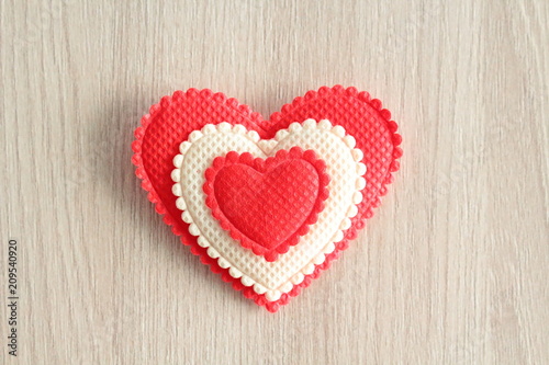 Heart made of cloth close-up on a wooden surface. Close-up. Background. Texture.