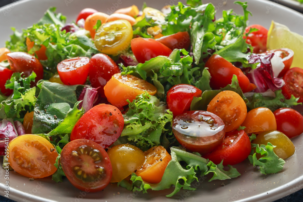 Fresh Cherry Tomato mix salad with lettuce, lemon, lime, black pepper and sea salt. healthy food Fresh Cherry Tomato mix salad with lettuce, lemon, lime, black pepper and sea salt. healthy food