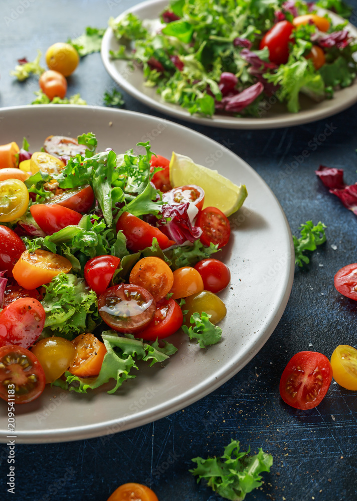 Fresh Cherry Tomato mix salad with lettuce, lemon, lime, black pepper and sea salt. healthy food