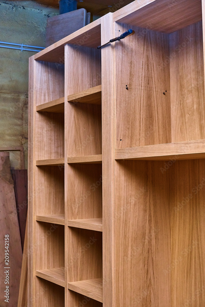 Joinery. Oak veneered mdf wardrobe in workshop. Wooden furniture. Details wood production Joinery. Oak veneered mdf wardrobe in workshop. Wooden furniture. Details wood production