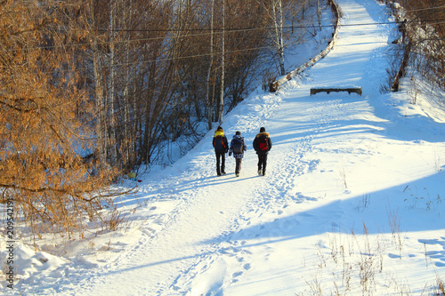 Children return home from school on the road across the bridge. Russia, January, 2018.