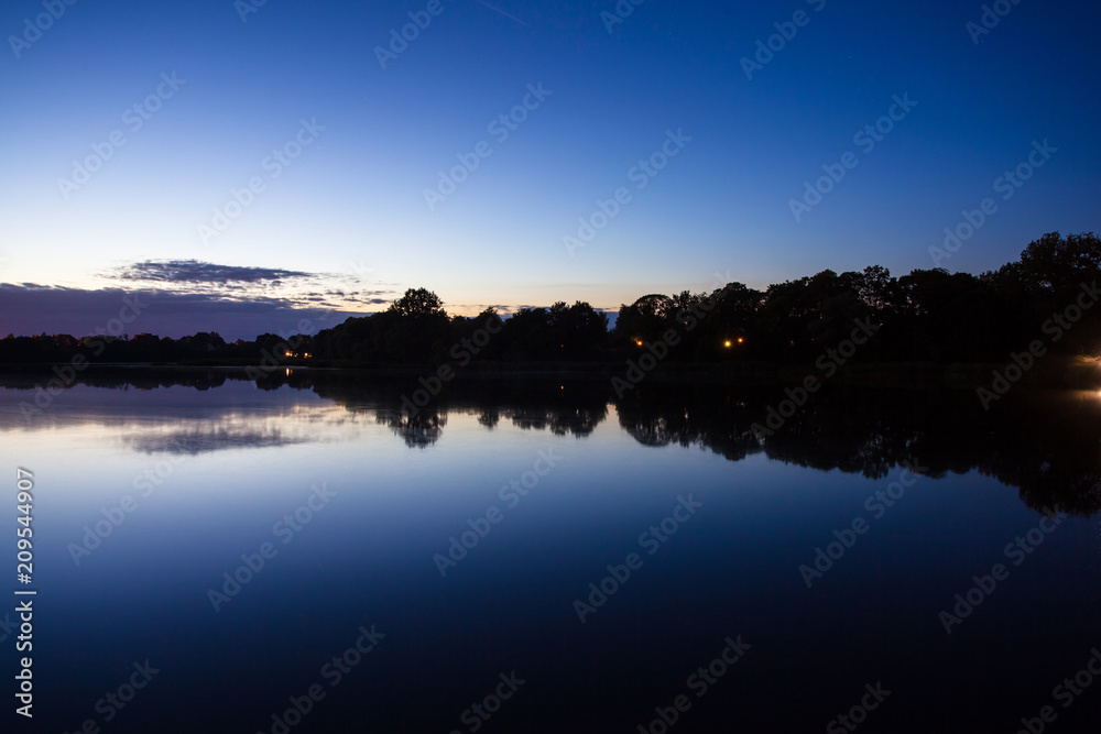 Obraz premium forest by the lake at dusk, long exposure