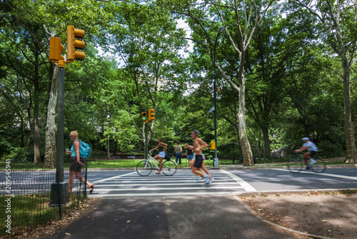 People jogging and cycling at the Central Park in New York City, USA; Concept for healthy lifestyle