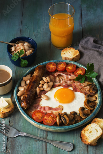Full English Breakfast With Scrambled Eggs Sausage Mushrooms Beans And Bacon On A Wooden Rustic Green Table Toast With Butter Coffee And Orange Juice Foto De Stock Adobe Stock
