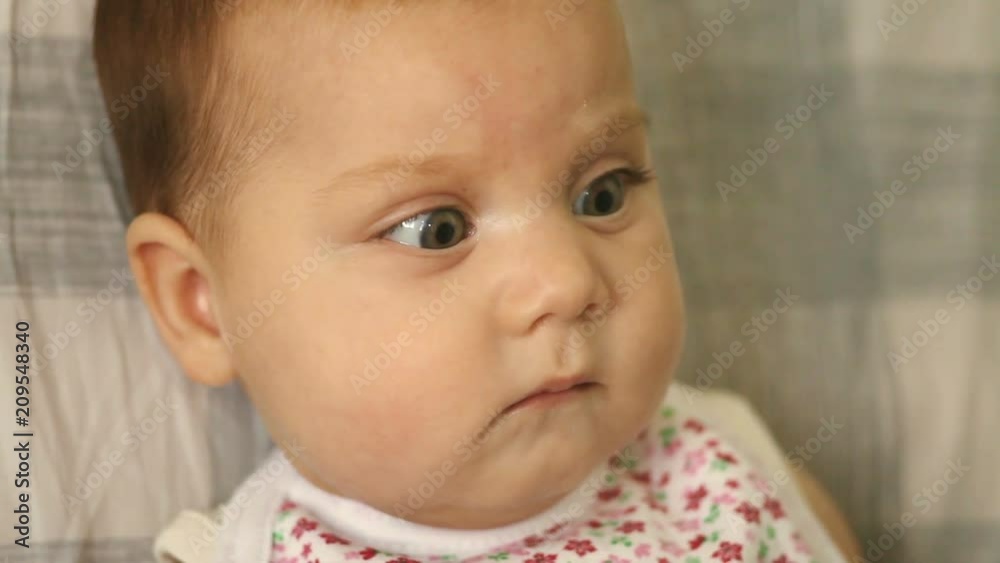 Young mother feeding baby baby food with spoon Young mother feeding baby baby food with spoon