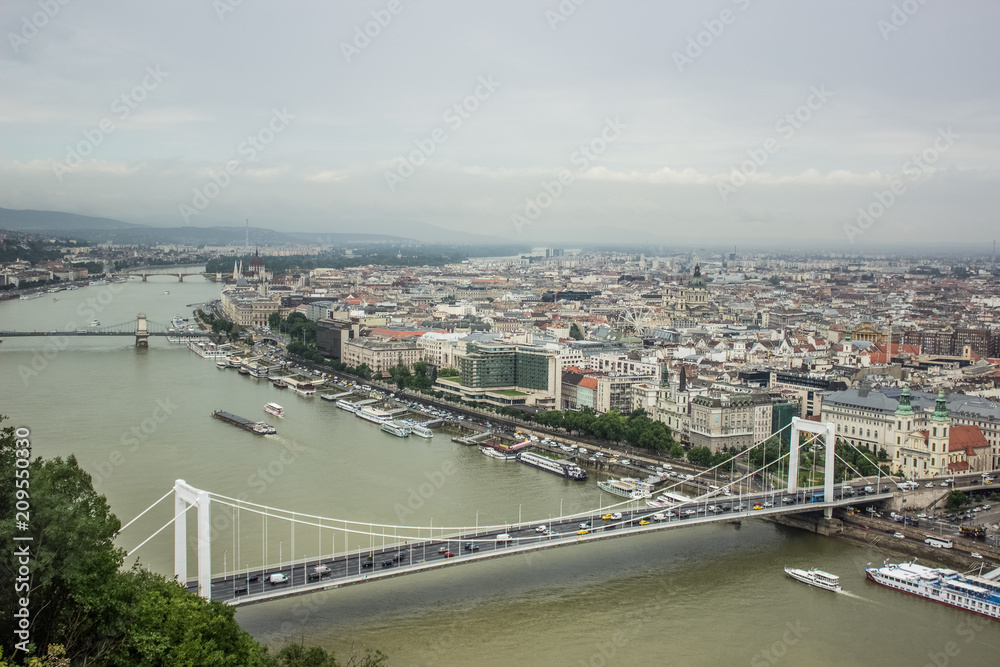 Budapest in rainy and fog day waterfront urban city district scape from above top of hill with mountain on horizon view 