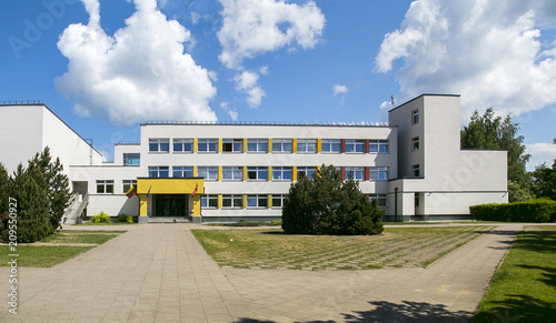 Public school building. Exterior view of school building with playground. photo