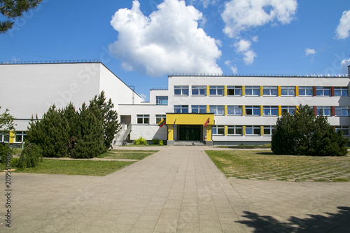 Public school building. Exterior view of school building with playground.