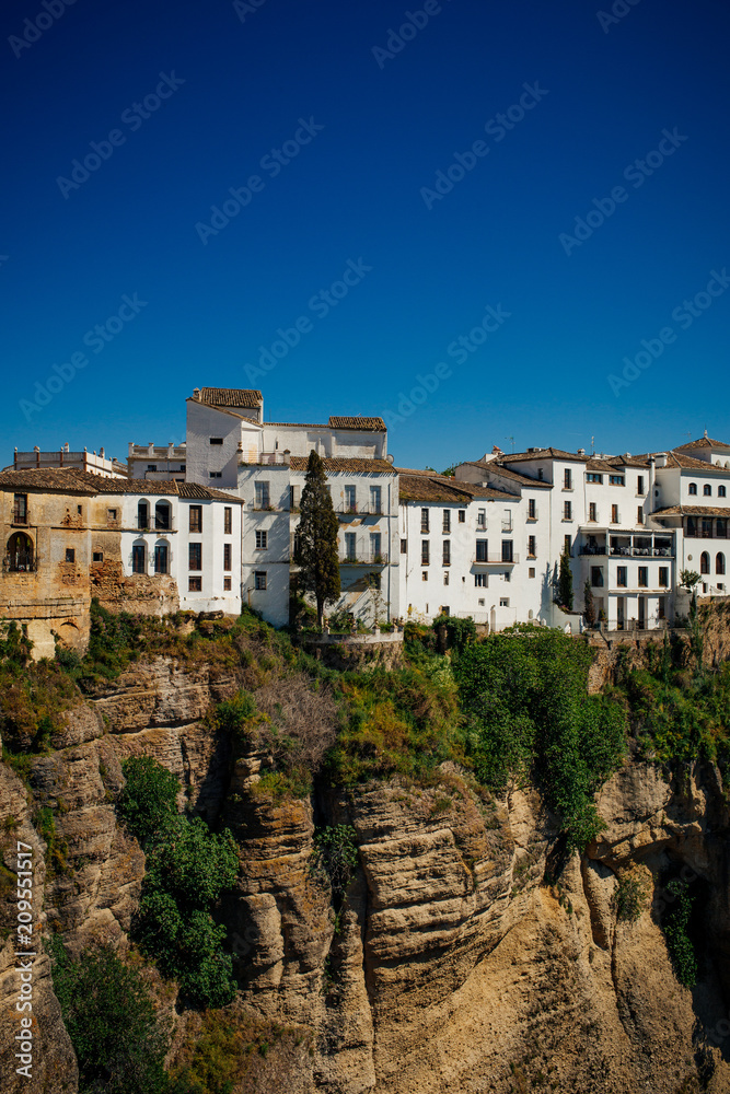White houses on the edge of a cliff in Ronda, Andalusia, Spain.