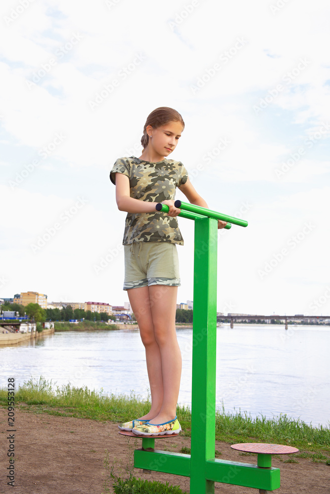 A teenager girl trains on a disk simulator on a city background