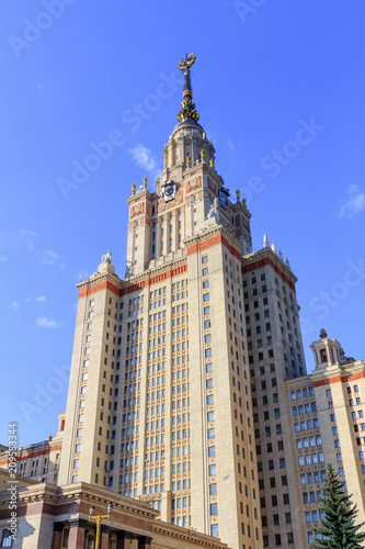 Tower above entrance to Lomonosov Moscow State University (MSU) on a blue sky background