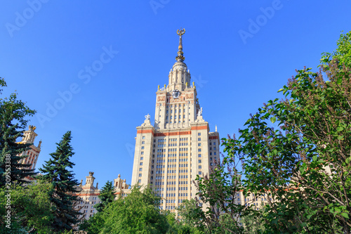 Moscow State University (MSU) in sunny summer evening on a green trees background