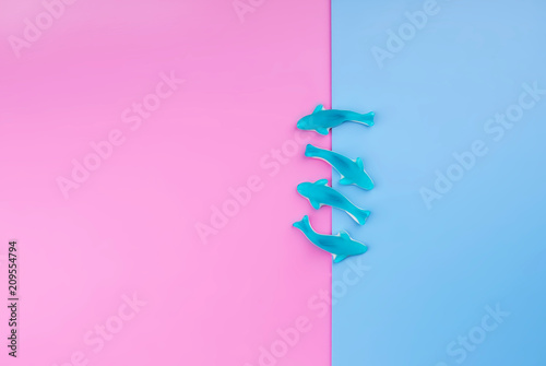 Jelly fish candies on pink blue background. Word SEA. Flat lay