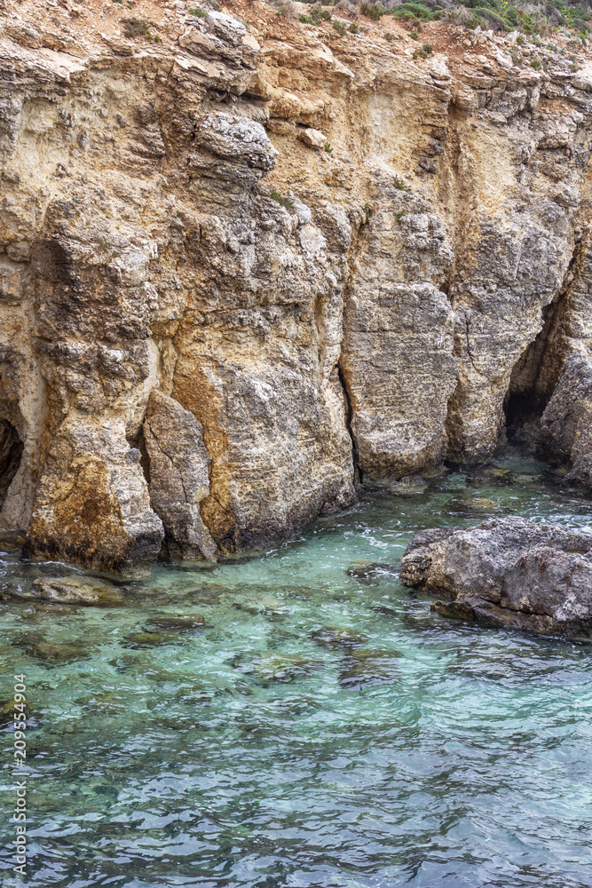 Comino coastline limestone cliffs and the clear Blue Lagoon water, Comino Island, Malta Comino coastline limestone cliffs and the clear Blue Lagoon water, Comino Island, Malta