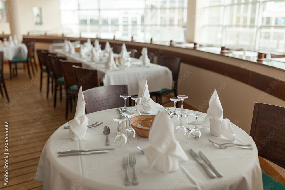 Beautiful table served with glassware and cultery, prepared for festive event. Special occasion celebrted in luxury restaurant or cafe. Table setting concept. Wedding table Beautiful table served with glassware and cultery, prepared for festive event. Special occasion celebrted in luxury restaurant or cafe. Table setting concept. Wedding table