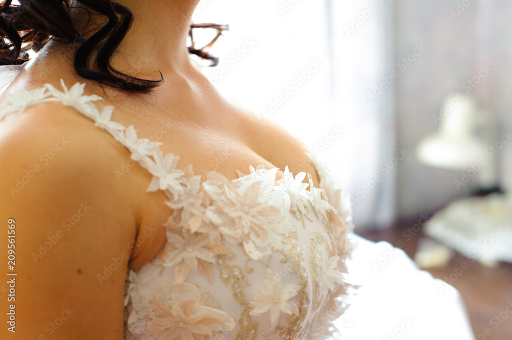 Big beautiful female breast. The bride in a white dress with a deep  decollete. Morning gathering of the bride. Stock Photo | Adobe Stock