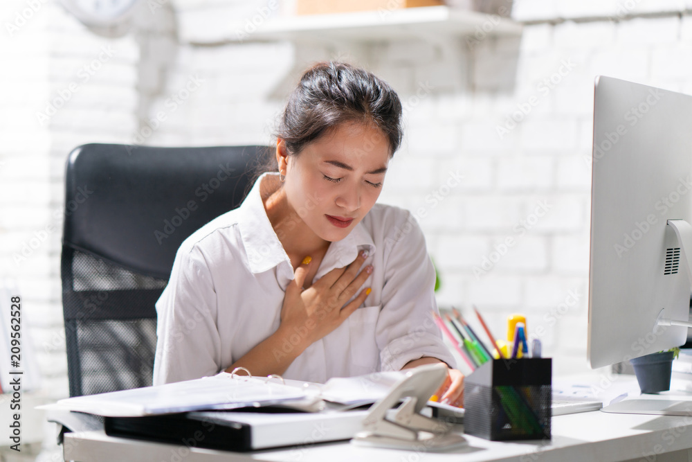 Business woman heart disease she is working in an office. Business woman heart disease she is working in an office.