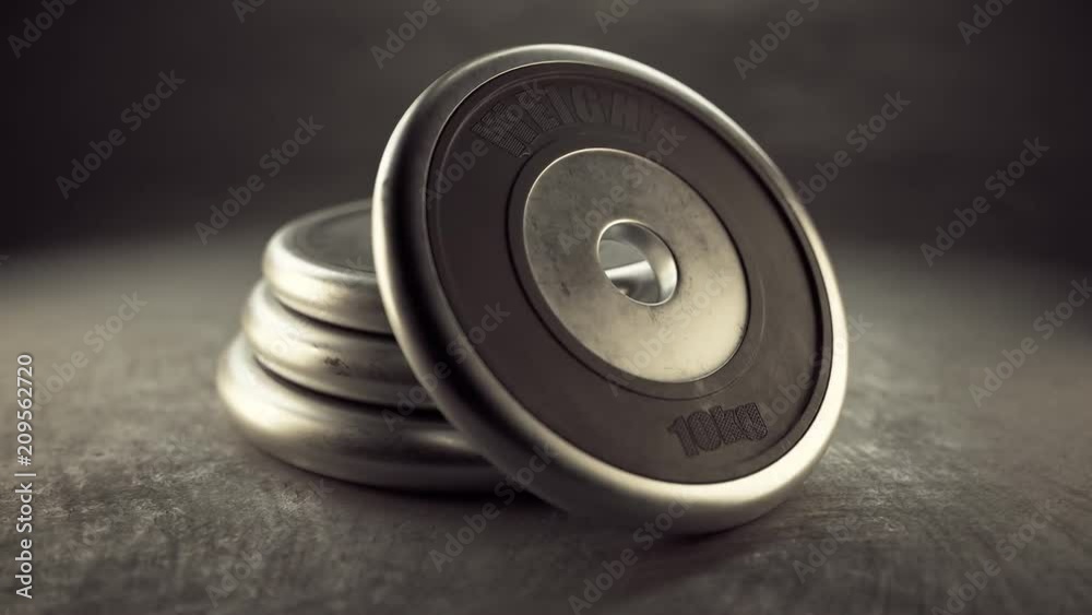 Cast iron black barbell plates isolated on gym floor. Health, fitness, strength