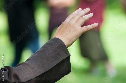 closeup of hands of woman making tai chi in urban park