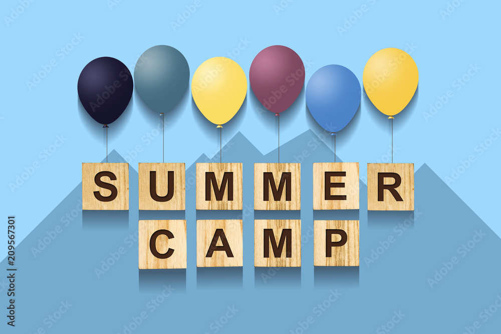 Summer Camp. Concept with words on wooden cubes and inflatable balls. Blue background. Summer Camp. Concept with words on wooden cubes and inflatable balls. Blue background.