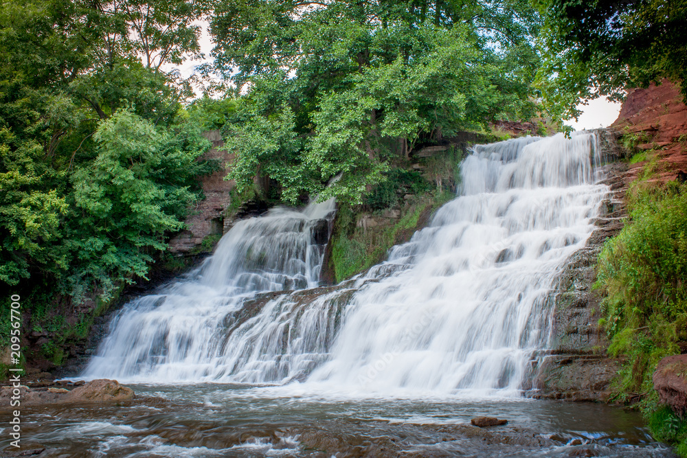 Obraz premium Dzhurinsky waterfall - a waterfall on the river Dzhurin in Zaleschitsky district of Ternopil region of Ukraine. The height of the waterfall is 16 meters.