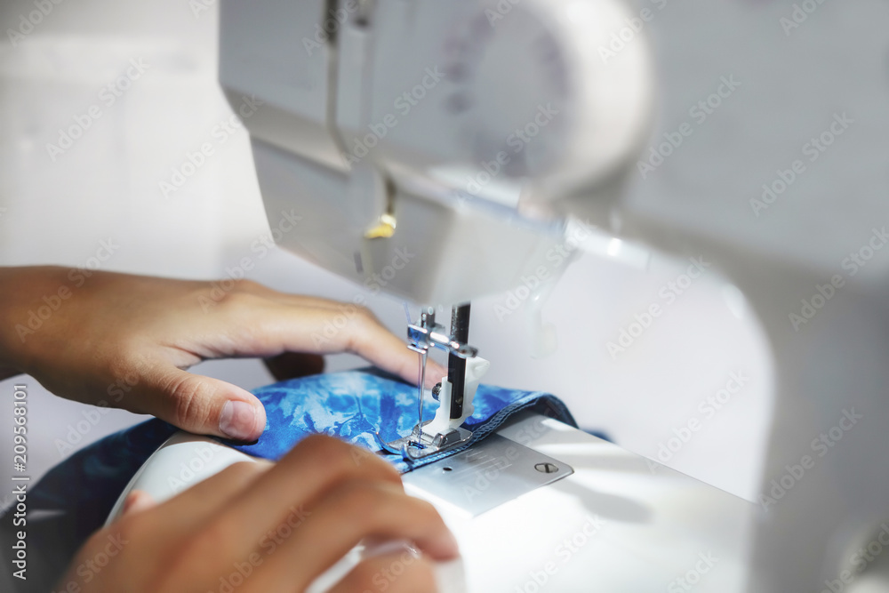 ailoring Process - Women's hands behind her sewing ailoring Process - Women's hands behind her sewing