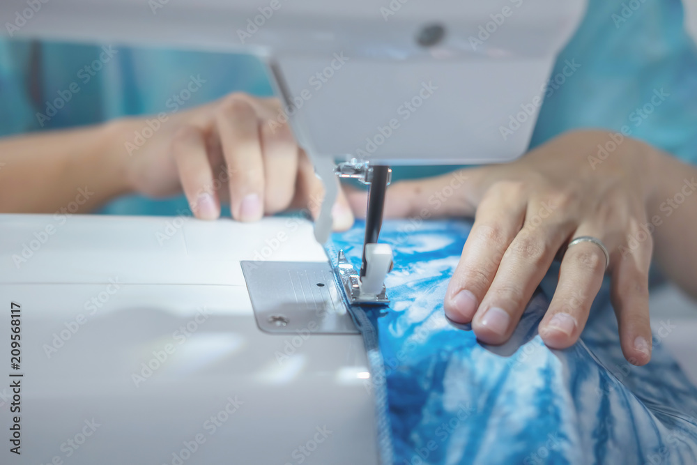 ailoring Process - Women's hands behind her sewing