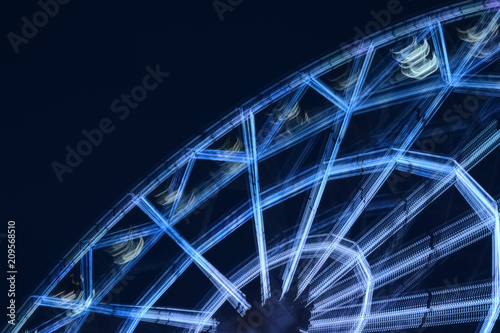Defocused ferris wheel with colorful lights  Blur abstract background. amusement