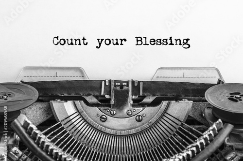 Count your Blessing text typed on a Vintage typewriter. Old paper, close-up.