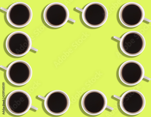 A pattern of small coffee cups on a bright colored background with copyspace