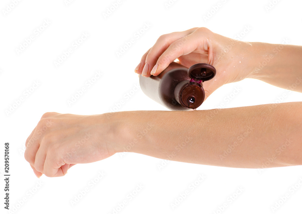 Female hands beauty bottle body cream oil on white background isolation Female hands beauty bottle body cream oil on white background isolation