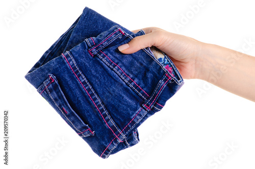 Children's blue jeans in hand on white background isolation