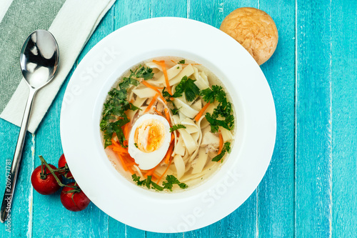 chicken soup, noodles, home cooking, blue wood background, egg