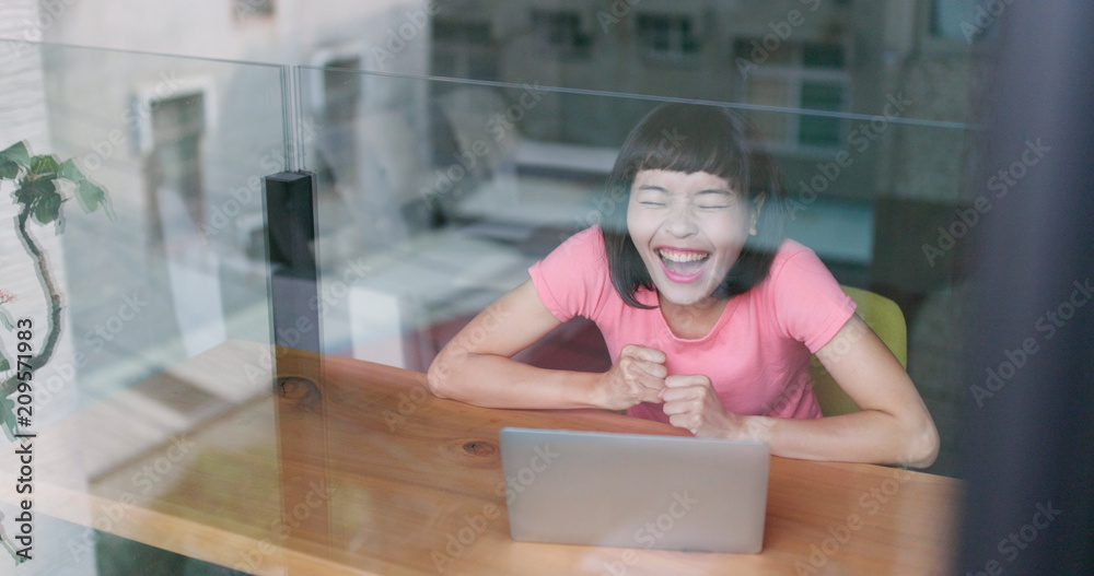 Excited woman using laptop computer for shopping online and win the prizes Excited woman using laptop computer for shopping online and win the prizes