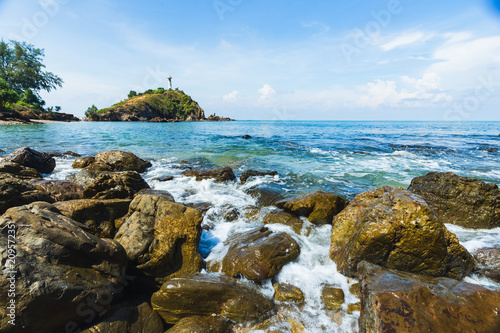 The lighthouse and rocky sand beach with blue sky and daylight on Koh Lanta.