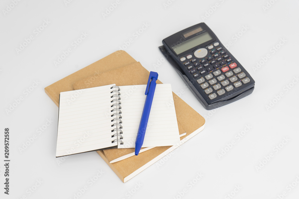 Stationery set such as Note books ,Pen and Calculator on white background. Stationery set such as Note books ,Pen and Calculator on white background.