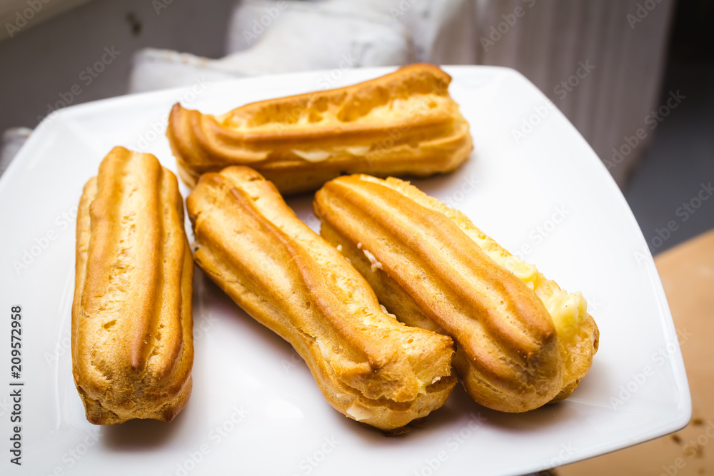 Homemade eclairs on a white plate