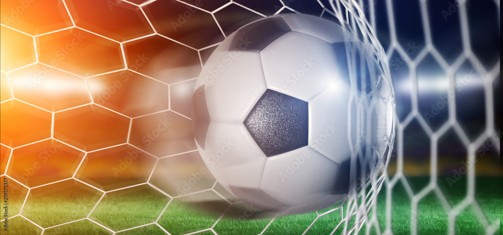 Naklejka premium Football ball in the net of a goal - 3d rendering
