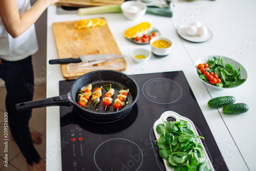 Fresh organicvegetables on white desk background on cutting board. Healthy natural food on rustic wood. Tomato, lettuce, carrot, pepper, zucchini and other cooking ingredients top view photo