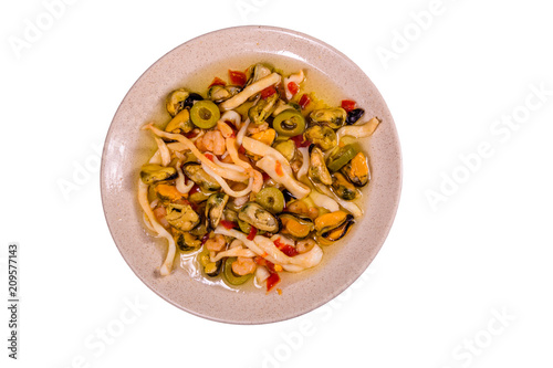 Ceramic plate with the different sea food and olives isolated on white background