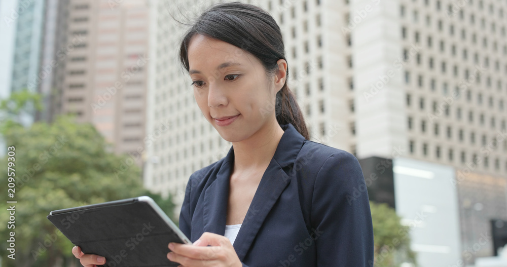 Businesswoman check on tablet computer at outdoor Businesswoman check on tablet computer at outdoor