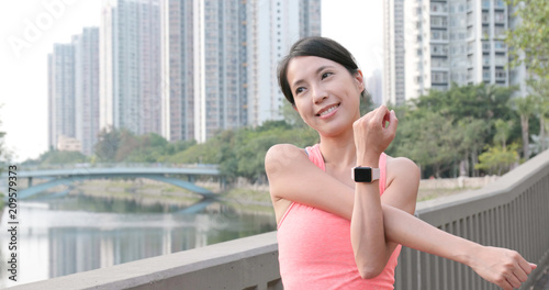 Free Download Sport Woman stretching hand at outdoor park - GFXLoad