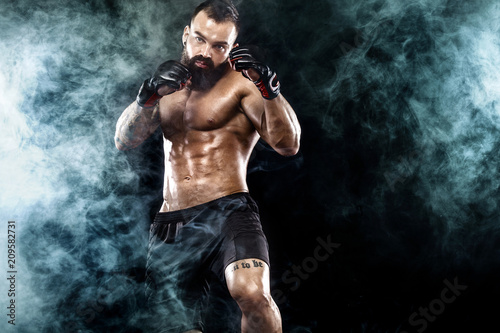 Sportsman boxer fighting on black background. Copy Space. Boxing sport concept.