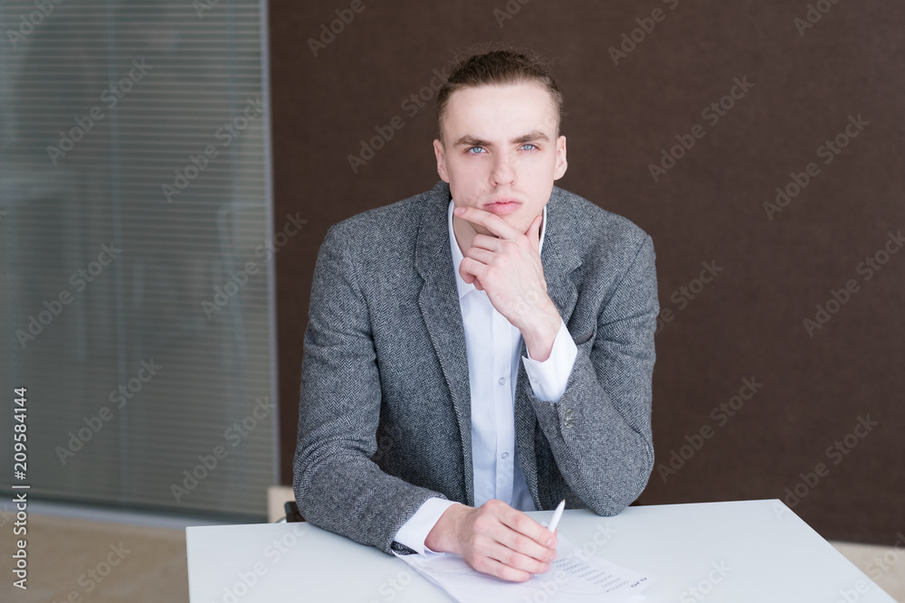 serious business man at work. corporate manager at his workplace. thoughtful pensive office worker serious business man at work. corporate manager at his workplace. thoughtful pensive office worker