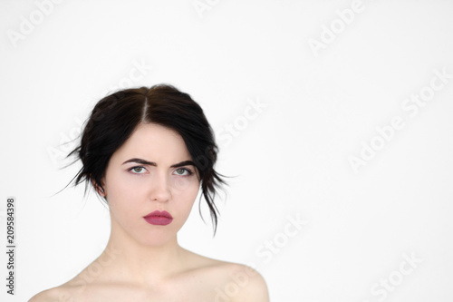 emotion face. moody grumpy sullen frowning woman. young beautiful brunette girl portrait on white background.
