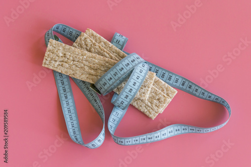 the loaves and the tape diet slim health on a pink background. slimming loaves