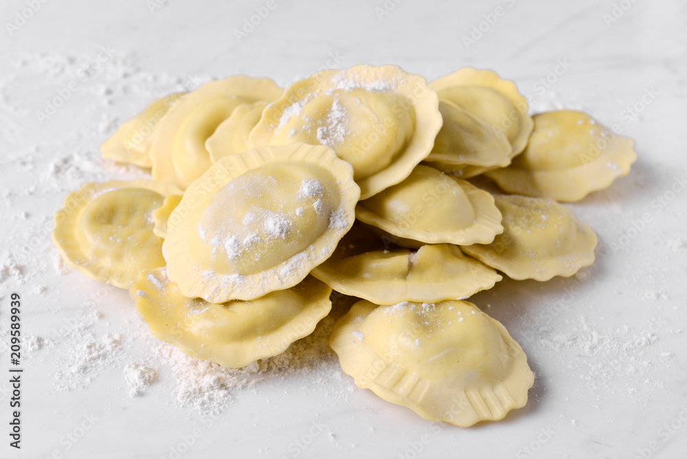 uncooked ravioli on marble