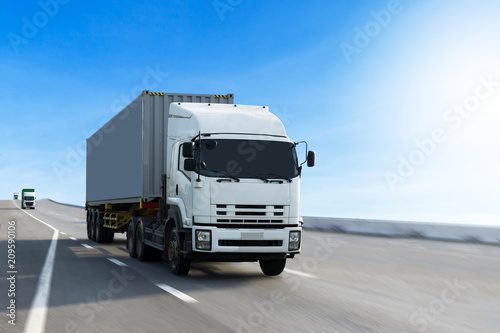 Truck on highway road with container, transportation concept.,import,export logistic industrial Transporting Land transport on the asphalt expressway. © BigBlues