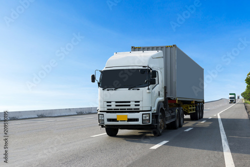 Truck on highway road with container, transportation concept.,import,export logistic industrial Transporting Land transport on the asphalt expressway.