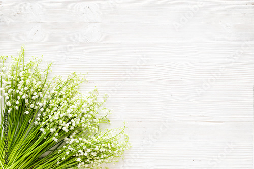 Small and fragrant spring flowers. Bouqet of lily of the valley flowers on white background top view copy space